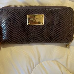 I am selling a purple skin Michael Kors wallet
